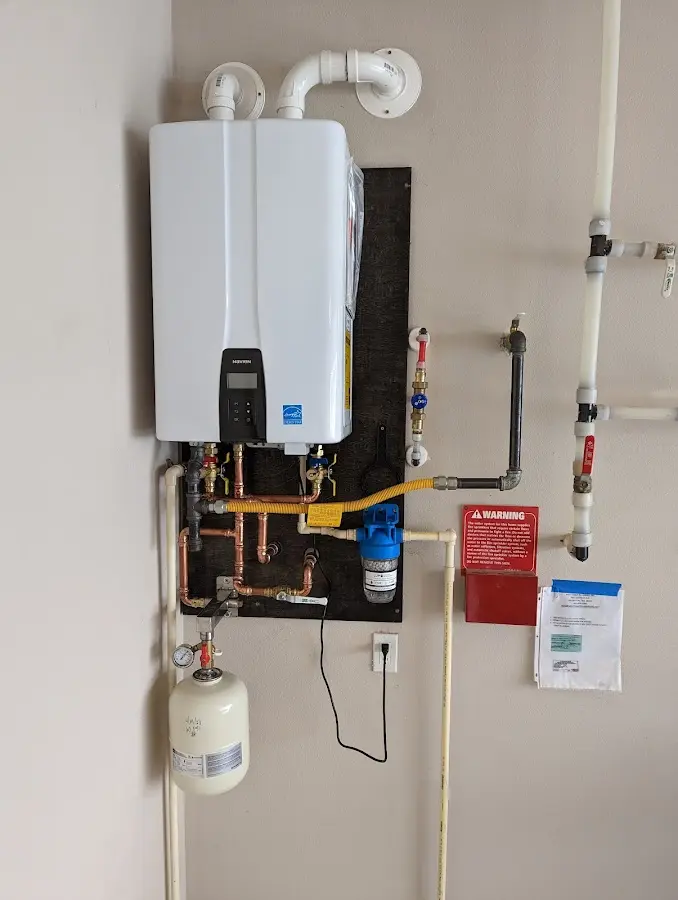 Professional plumber installing copper piping in a Byron home
